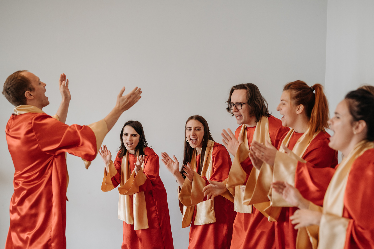 Church Choir in Orange and White Uniform Clapping   while Singing